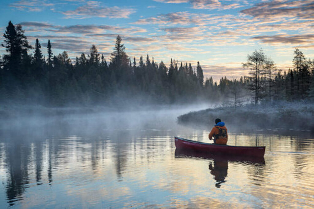 Man in a canoe in the sunset