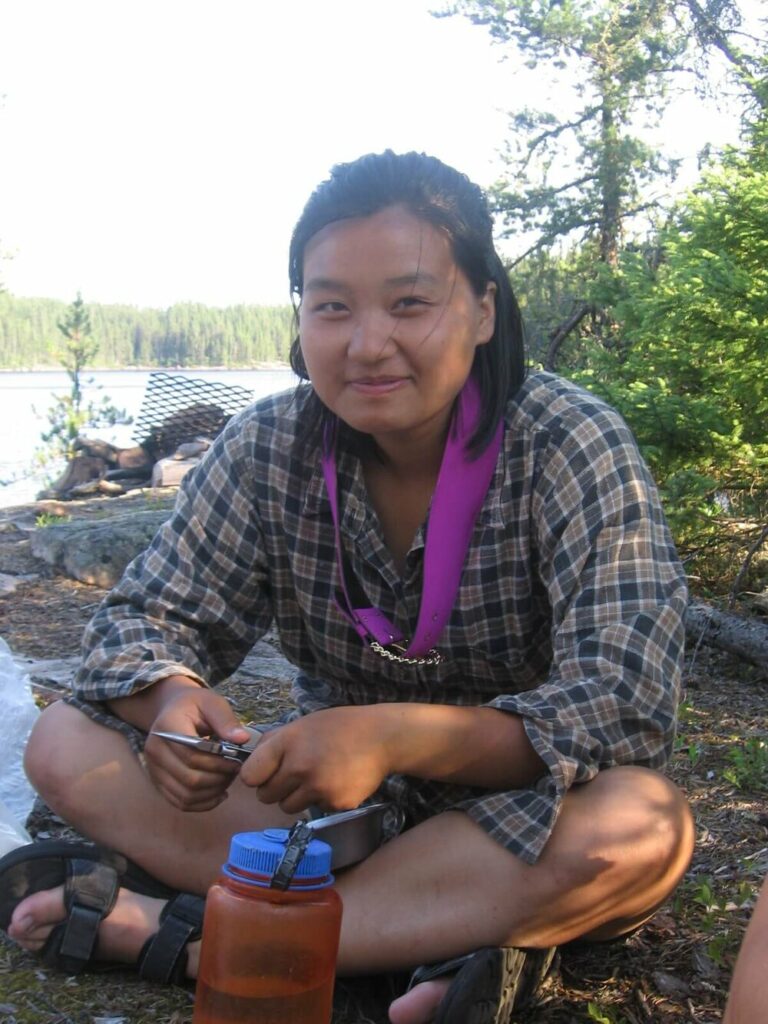 Lee Vue sitting by a lake