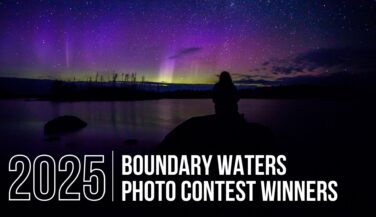 Night sky over the Boundary Waters illuminated by the aurora borealis.