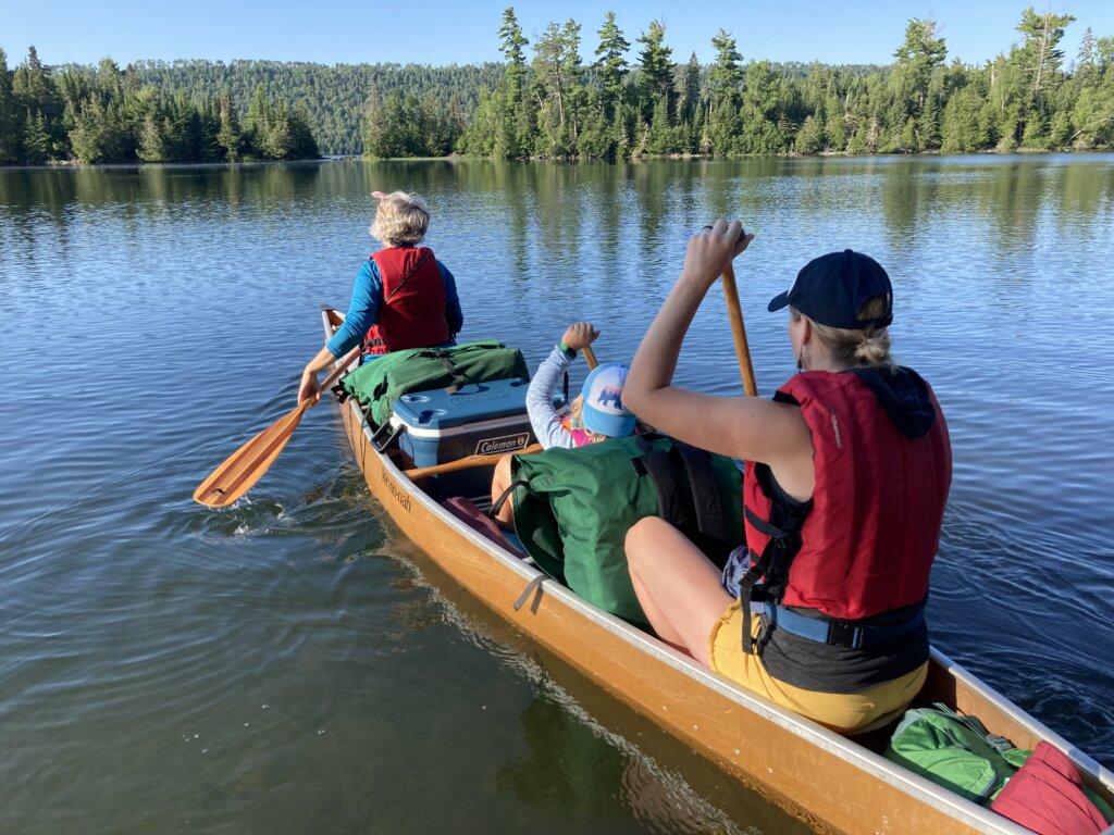 Three paddlers in canoe in the Boundary Waters