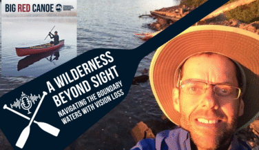 A graphic for the Boundar Waters Beyond Sight Podcast showing a man in a hat on a Boundary Waters shoreline miraculously taking a selfie, even though he probably can't see the picture much at all.