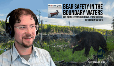 Alex Messenger with headphones looks over at the image of a bear ambling across the Boundary Waters Title: Bear Safety in the Boundary Waters with Alex Messenger