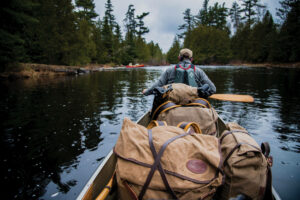 Canoe paddler with portage pack in the BWCA