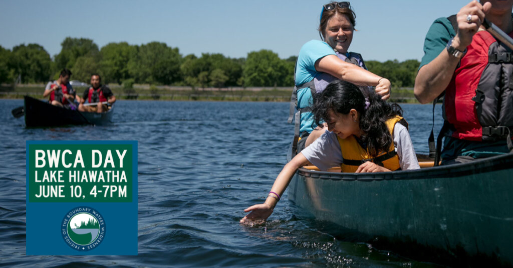Girl reaching down from a canoe in a lake to touch the water. Text: BWCA Day Lake Hiawatha, June 10, 4-7pm