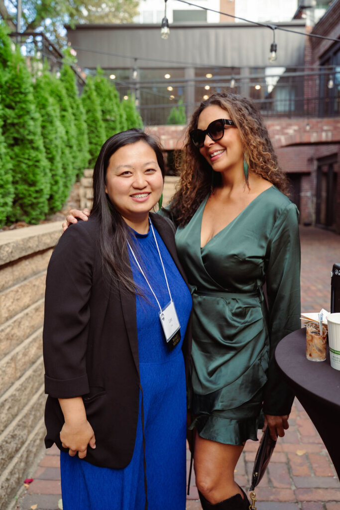 Two women on an outdoor patio smiling