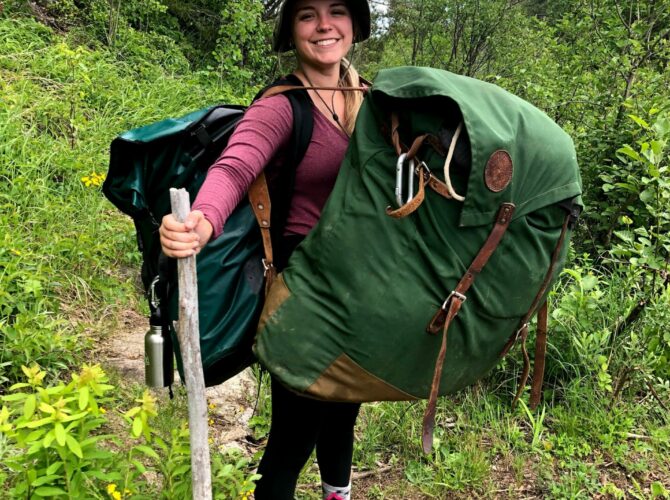 Woman with portage packs on a BWCA trail