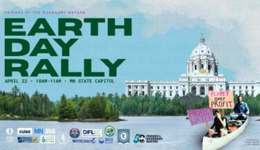 A picture of the capitol, with a canoe and people with signs in it, saying 