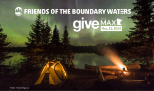 A nighttime Boundary waters scene with fire, canoe, lit up tent and aurora - with the words 