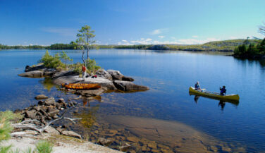 Canoe on a blue lake in the Boundary Waters