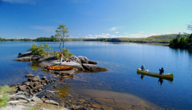 Canoe on a blue lake in the Boundary Waters