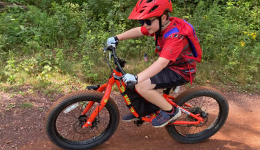 Kid riding on a dirt bike trail