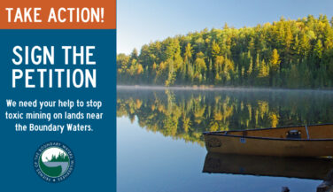 Canoe by a lake in the BWCA - Text says 