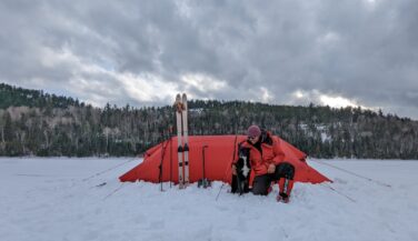 Emily Ford in front of a red tent in the BWCA