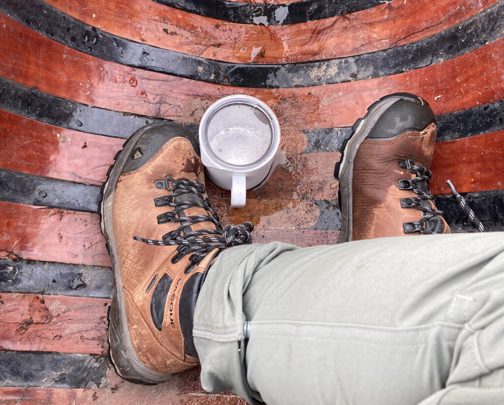 Photo: Sarah Stiles A mug tucked into the bottom of a wood-ribbed canoe, between a pair of hiking boots.