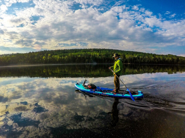 Image of a man using a stand up paddle board in the Boundary Waters