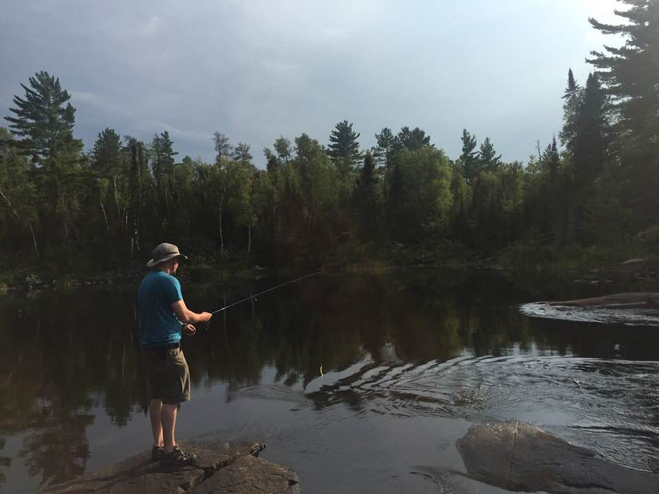 Man fishing from the shore in the BWCA.