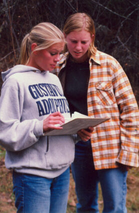 Two women looking at paperwork while at the Boundary Waters