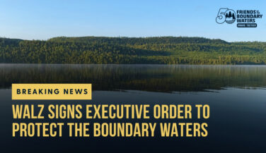 A hillside in the Boundary Waters with text 